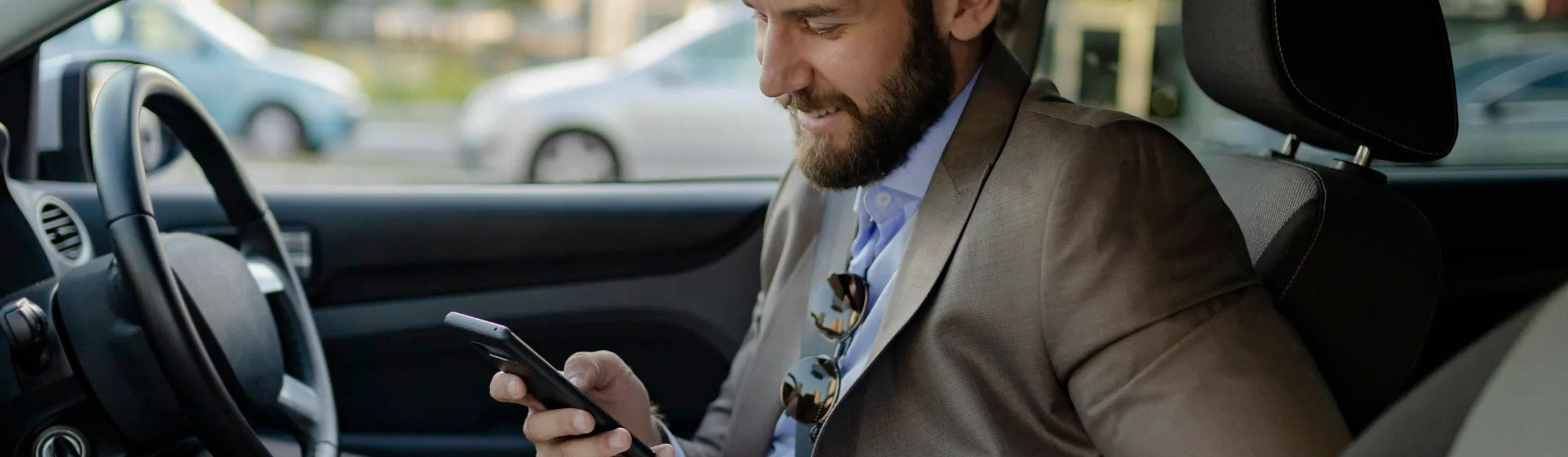 Man checking phone in car
