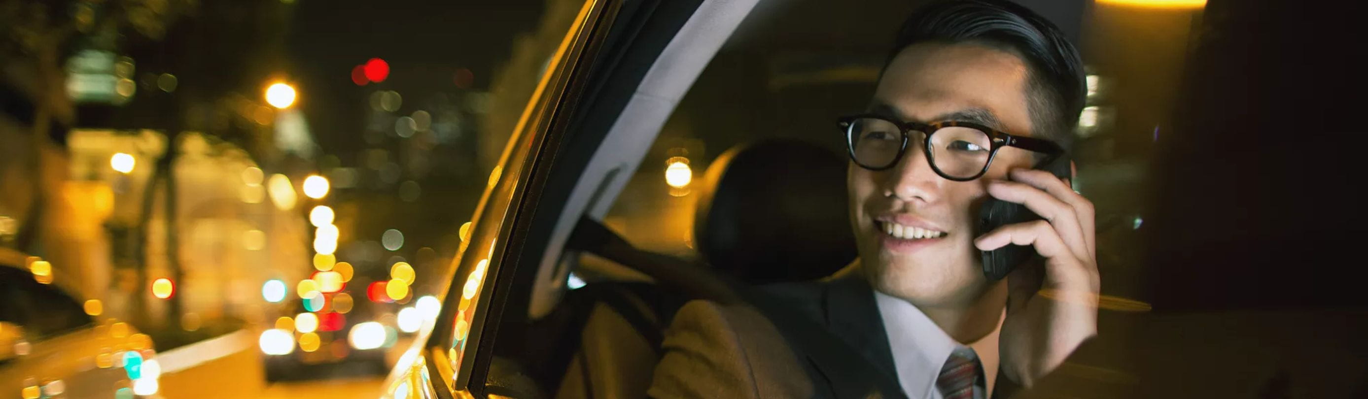 Man sitting in backseat of car