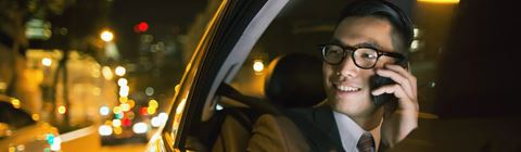 Man sitting in backseat of car