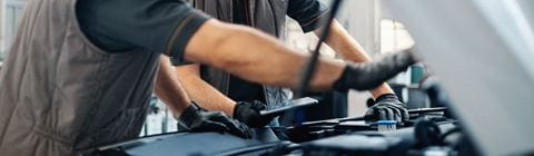 Mechanics working on car